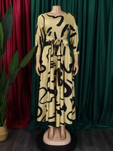 Detail view of ginger yellow floral midi dress with black abstract print and waist belt