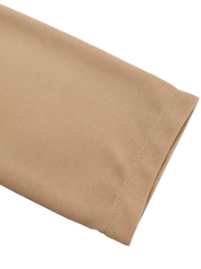Detailed close-up of khaki pencil dress sleeve with professional flat-seam edge finish