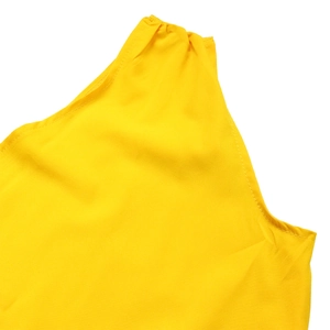 Detail of yellow one-shoulder dress showing pleated shoulder and fine stitching