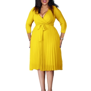 Detail of elegant yellow V-neck wrap midi dress with fine pleated skirt texture