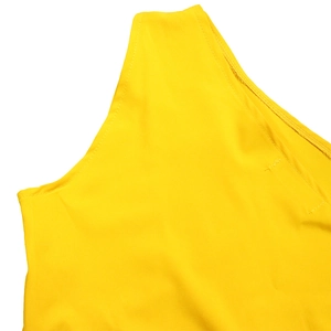 Detailed view of stitching and craftsmanship on a bright yellow one-shoulder dress