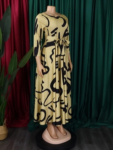 Detail of long sleeve midi dress featuring black abstract geometric patterns and belted waist