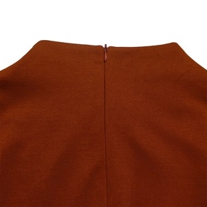 Detail of the high-quality invisible zipper and smooth knit fabric on the brown dress