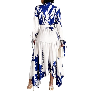 Detail of elegant white floral long sleeve dress with blue print and asymmetrical hemline
