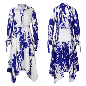 Detail of white shirt dress featuring asymmetrical hem and blue floral botanical prints