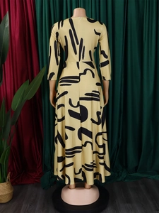 Rear view of yellow maxi dress with black abstract print showing back zipper and large hemline