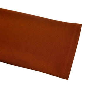 Detailed macro view of caramel knit dress sleeve with durable double-needle stitching