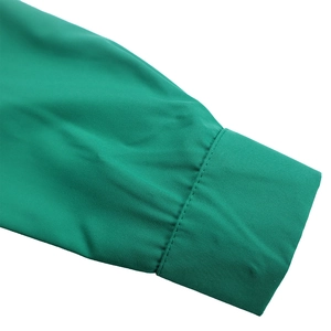 Detailed view of the emerald green puff sleeve cuff with precise double-needle stitching