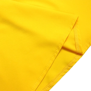 Close-up of high-quality sewing and stitching on a vibrant yellow woven fabric dress