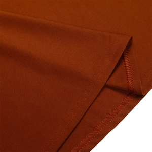 Macro detail of caramel pleated dress showing high-quality stitching and knit texture