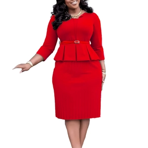 Detail of red V-neck dress featuring peplum hem and thin belt with silver buckle
