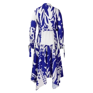 Detail view of the floral dress back featuring irregular hem and elegant ribbon cuffs