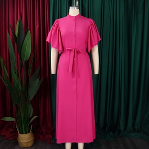 Detail of hot pink dress showing button-down front, belt, and tiered ruffle sleeves