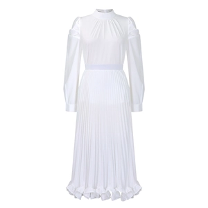 Detail of elegant white puff sleeve top and pleated skirt with ruffled hemline accents