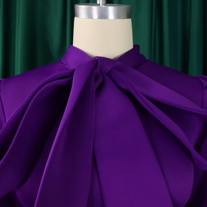 Macro detail of high-quality purple satin dress neckline with an elegant bow tie design