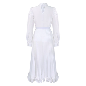 Detail of white puff sleeve dress back featuring button closure and elastic pleated skirt