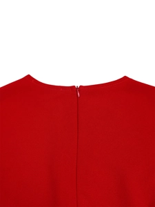 Close-up of red V-neck dress featuring a seamless invisible zipper and neat stitching