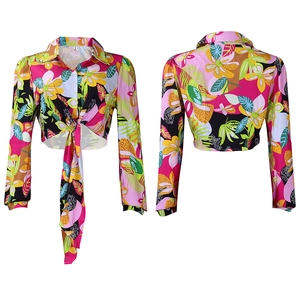 Detailed view of tropical floral print shirt with lapel collar and front waist tie detail