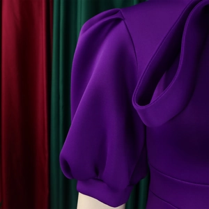 Close-up of deep purple puff sleeves showing high-quality stitching and pleated details
