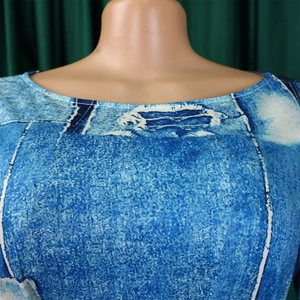 Détail du décolleté à épaules dénudées avec coutures blanches sur imprimé denim bleu