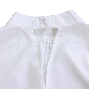 Close-up of white high-neck top featuring keyhole back design and elegant fabric pleats