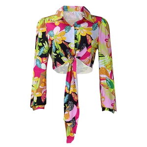 Detail of tropical floral print on women's cropped long sleeve shirt with tie-front waist