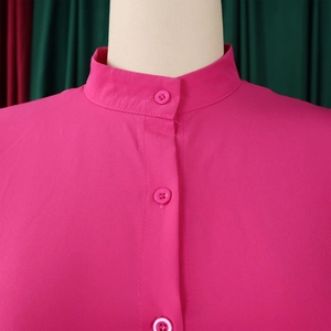 Detail of mandarin collar and button-down front on a vibrant magenta summer dress
