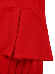Detailed close-up of the red pleated hem featuring high-quality stitching and silky fabric