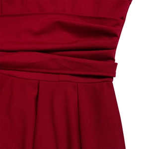 Detailed view of dark red pleated dress with a cinched waist and elegant fabric texture