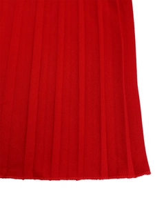 Detailed macro view of red pleated fabric with professional overlock stitching on the edge