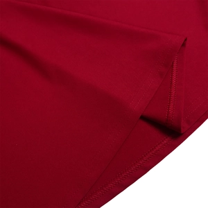 Detail of red knit dress hem showing precise double-needle stitching and fabric texture