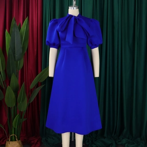 Close-up of royal blue evening dress with elegant bow collar and puff sleeves detail