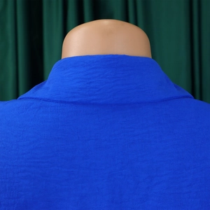 Detailed view of the royal blue collar and crinkle texture fabric of the shirt