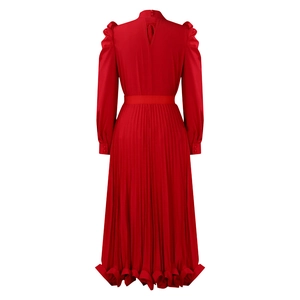 Detail view of the back of a red puff sleeve top with a pleated skirt and teardrop cutout
