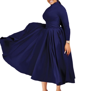 Detail of elegant navy blue maxi dress featuring pleated dynamic skirt and slim fit waist