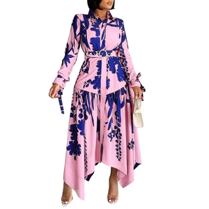 Detail of floral print maxi dress with irregular hem and pearl buckle waist belt