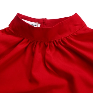 Detailed view of red puff sleeve top featuring a pleated stand collar and high-quality fabric