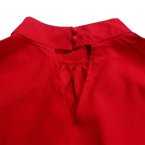 Close-up of red puff sleeve top neckline with keyhole cutout and double button closure