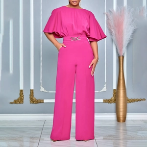 Detail of rose red wide-leg jumpsuit featuring elegant cape sleeves and silver waist buckle