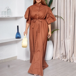 Detail of a brown maxi dress with ruffle sleeves, button-down front and waist tie belt