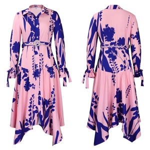 Detail of pink floral shirt dress featuring rhinestone belt and asymmetric hemline
