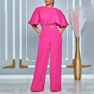 Detail of magenta wide-leg jumpsuit showing high waist with silver chain metal belt