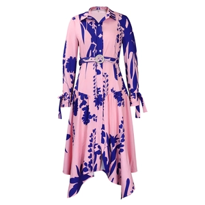 Detail of pink floral print shirt dress with rhinestone belt buckle and irregular hem