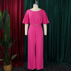 Detail view of rose pink wide-leg jumpsuit with ruffled sleeves and gold buckle belt