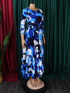 Detail of long-sleeved midi dress featuring blue camouflage print and a matching waist belt