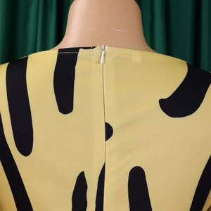 Détail de la robe jaune à motif abstrait noir avec fermeture éclair invisible au dos