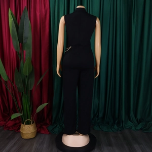 Back view of black sleeveless jumpsuit featuring a mandarin collar and gold waist chain detail