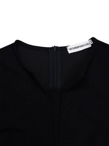 Detail shot of the V-neck invisible zipper and Metamorphosis Girl brand label in size M