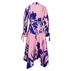 Detail showing the asymmetrical hemline and purple floral print on the pink midi dress