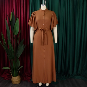 Detail of a brown vintage dress with layered ruffle sleeves and button-down front waist belt